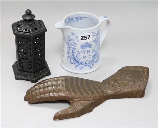 A Queen Victoria Golden Jubilee commemorative mug, a cast iron stove shaped money bank and an iron gauntlet shaped wall mount